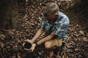 Organic farmer Jose Antonio González holding a sample of soil