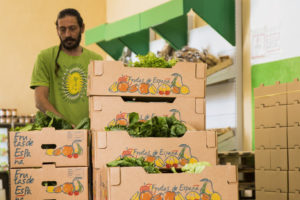 An employee of Guadalhorce Ecológico moving boxes of vegetables