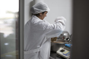 Bioles owner Leonor Sánchez filling a packet with loose grain