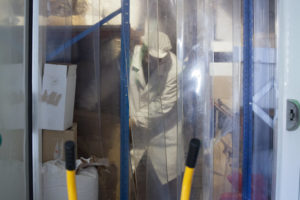 Bioles owner Carlos Aragon moving sacks of produce in a storage room