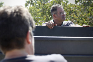 Pistachio farmer Gumersindo Sánchez during harvest, standing next to a truck