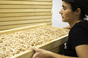 Arrate Corres holding a large tray of pasta