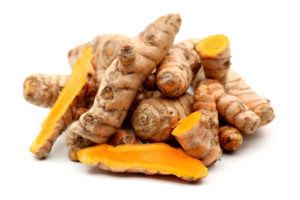 Photograph of whole and cut turmeric