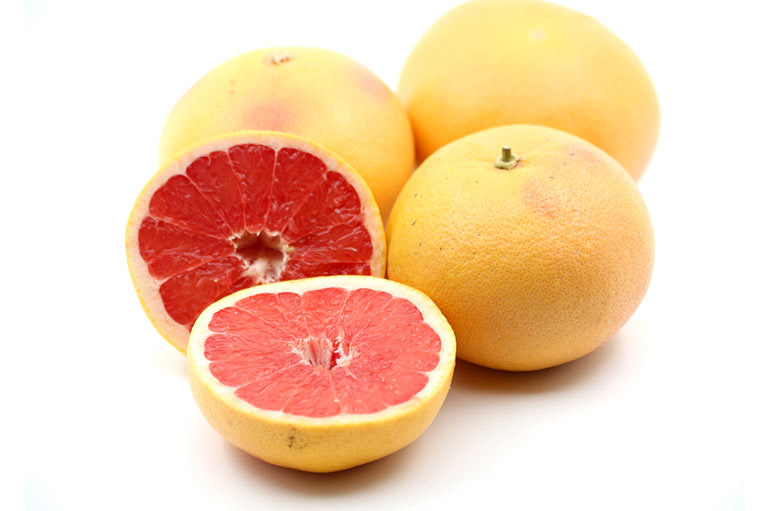 Photograph of whole and cut grapefruit