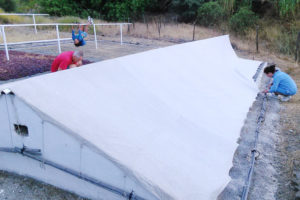 The large flat area for drying grapes being covered over at night