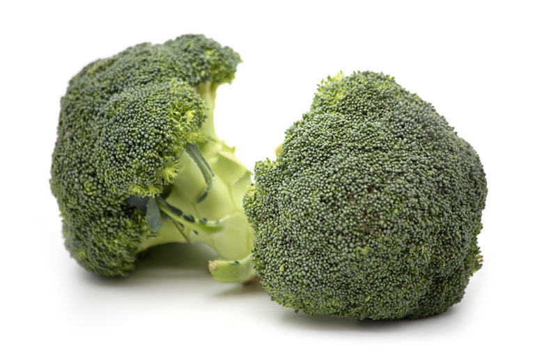 Photograph of two cut heads of green broccoli