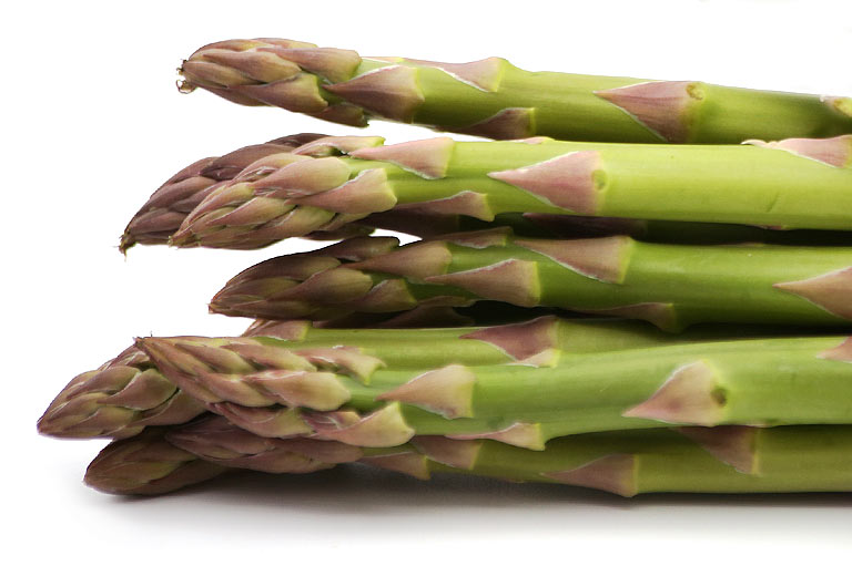 Close up photograph of the tips of green asparagus