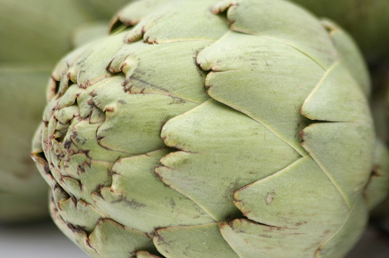 Close-up of an artichoke head, showing detail of the colour and texture