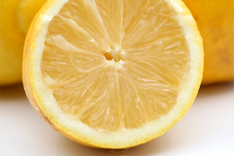Close up of whole and cut lemons