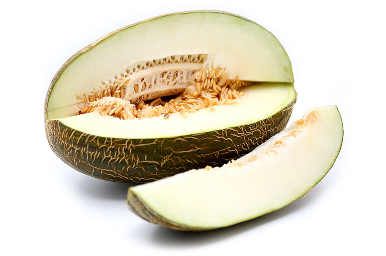 An oval Piel de Sapo melon, with rough dark green outer skin and a section cut out of it, showing the light green flesh and seeds inside