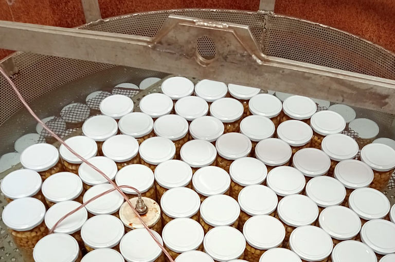 Closed jars of chick peas being preserved